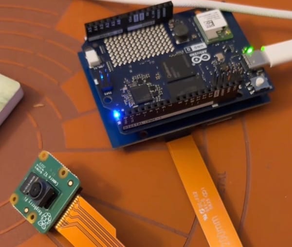 Arduino UNO Q with Camera Breakout Module / Board that is connected to a Raspberry Pi V2 camera.